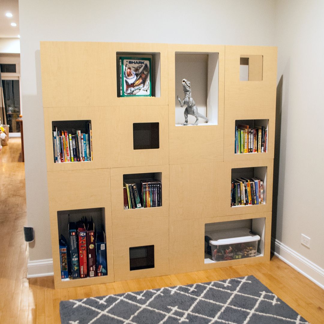 Maple double Cat Case in a playroom holding books, games and a toy dinosaur