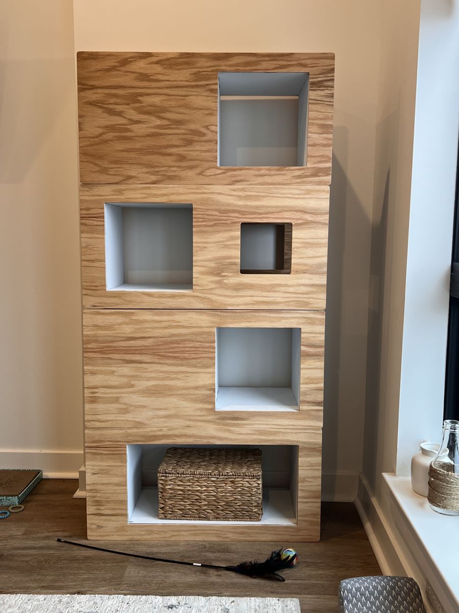 Oak Cat Case with white interiors and a woven basket in the bottom opening